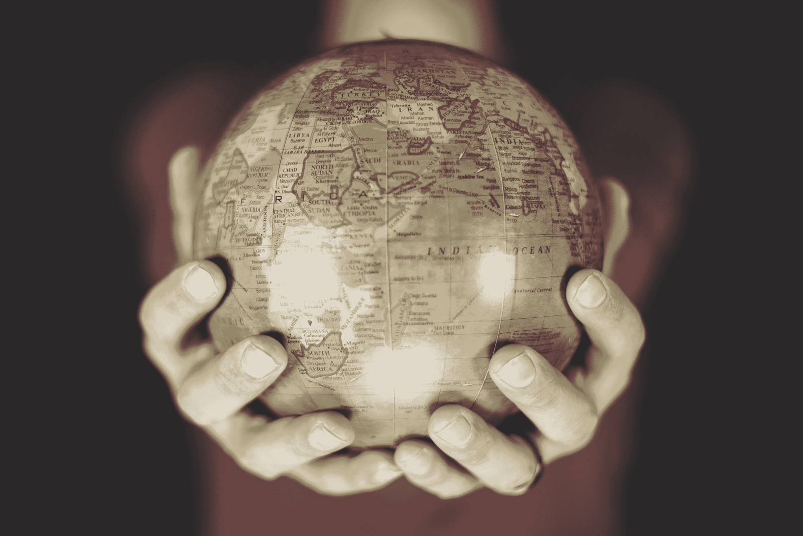 closeup-shot-person-holding-small-globe-with-two-hands-min-1-1